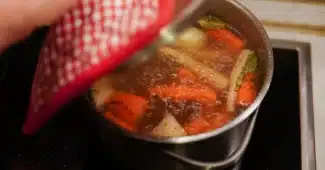 Légumes racines frais et herbes aromatiques sur un plan de travail rustique, prêts à la préparation culinaire.