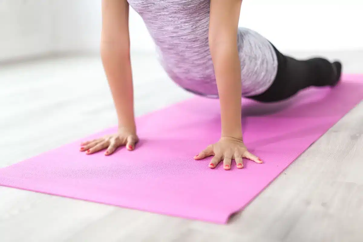 Femme pratiquant le yoga ou le Pilates dans une ambiance calme et zen