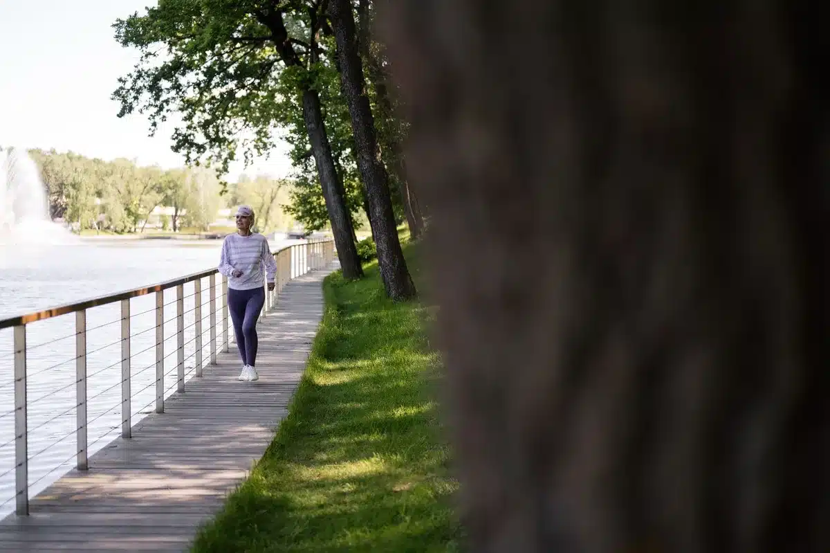 Personne en mouvement dans un environnement naturel, représentant l'activité physique adaptée