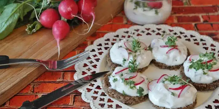 Bocal de cancoillotte versé sur une tranche de pain complet dans une cuisine en journée
